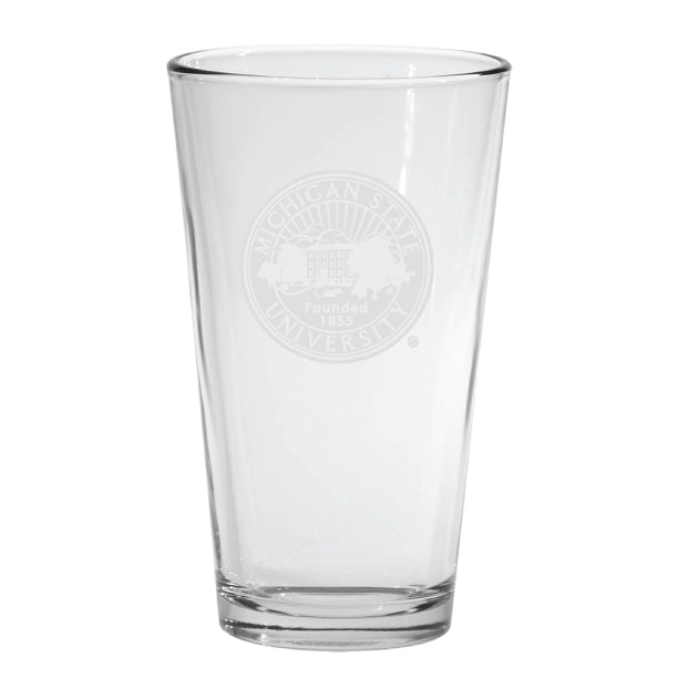 Clear Michigan State University pint glass featuring a frosted etched university seal with the text “Michigan State University” and “Founded 1855” centered on the front. The heavy-bottom glass has straight sides and a thick base,
