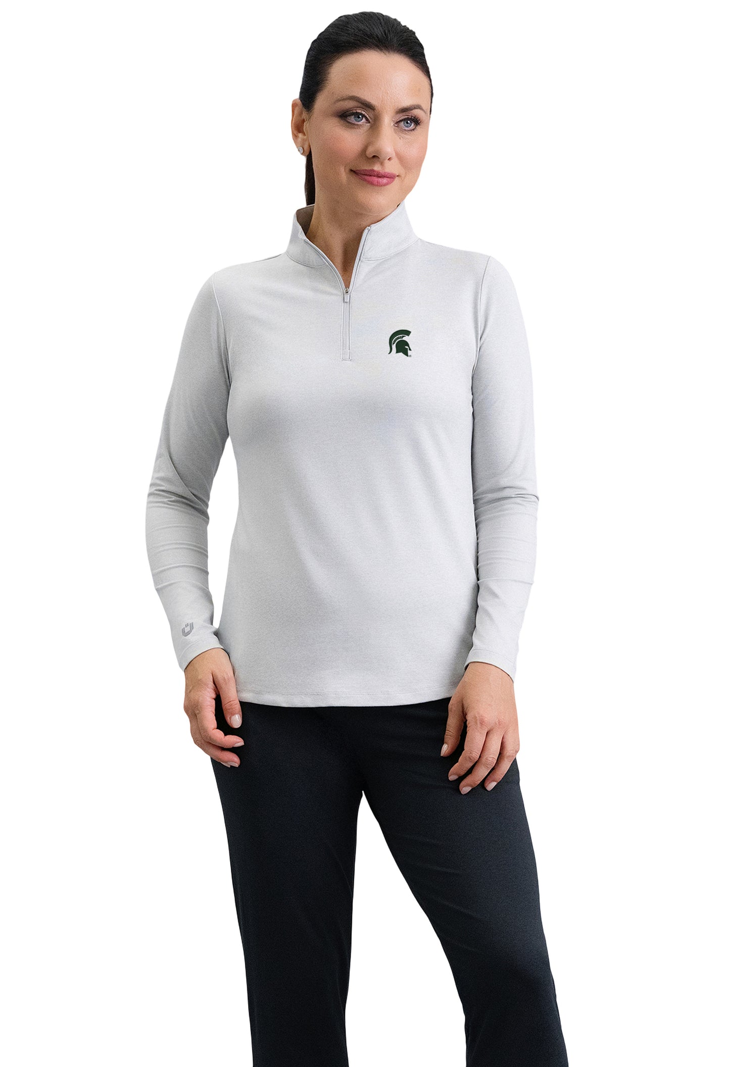 Woman wearing a white fitted quarter-zip with a green Spartan Helmet logo on the upper left chest.
