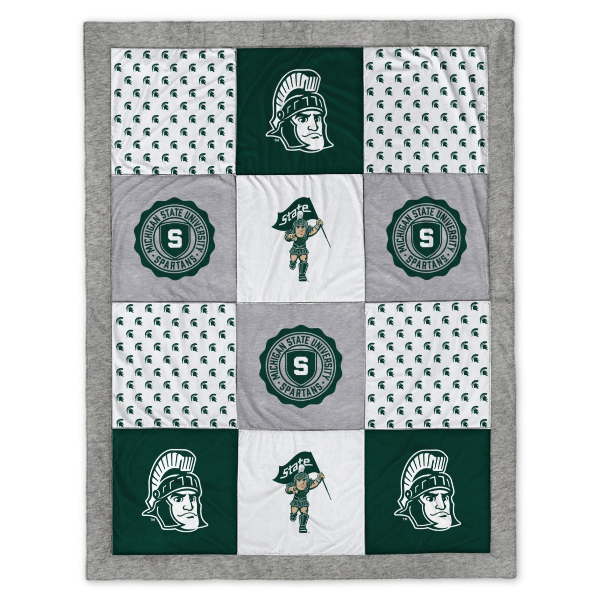 A patchwork blanket of gray, green, and white fabric with various MSU and Sparty motifs.