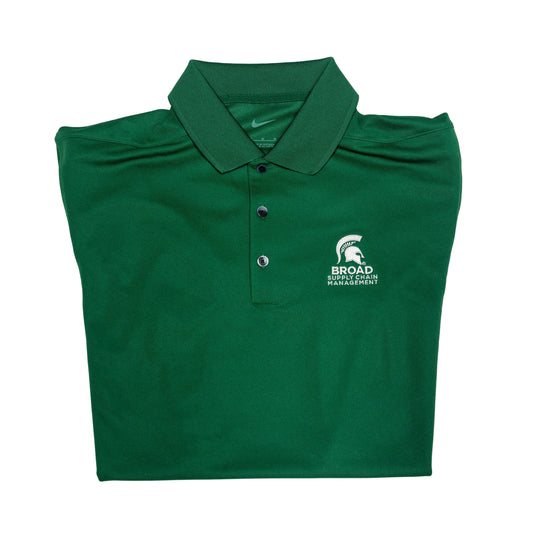 Close-up of a folded green Nike collared polo with three buttons. A white Spartan Helmet over the Broad Supply Chain Management logo is embroidered on the left upper chest.