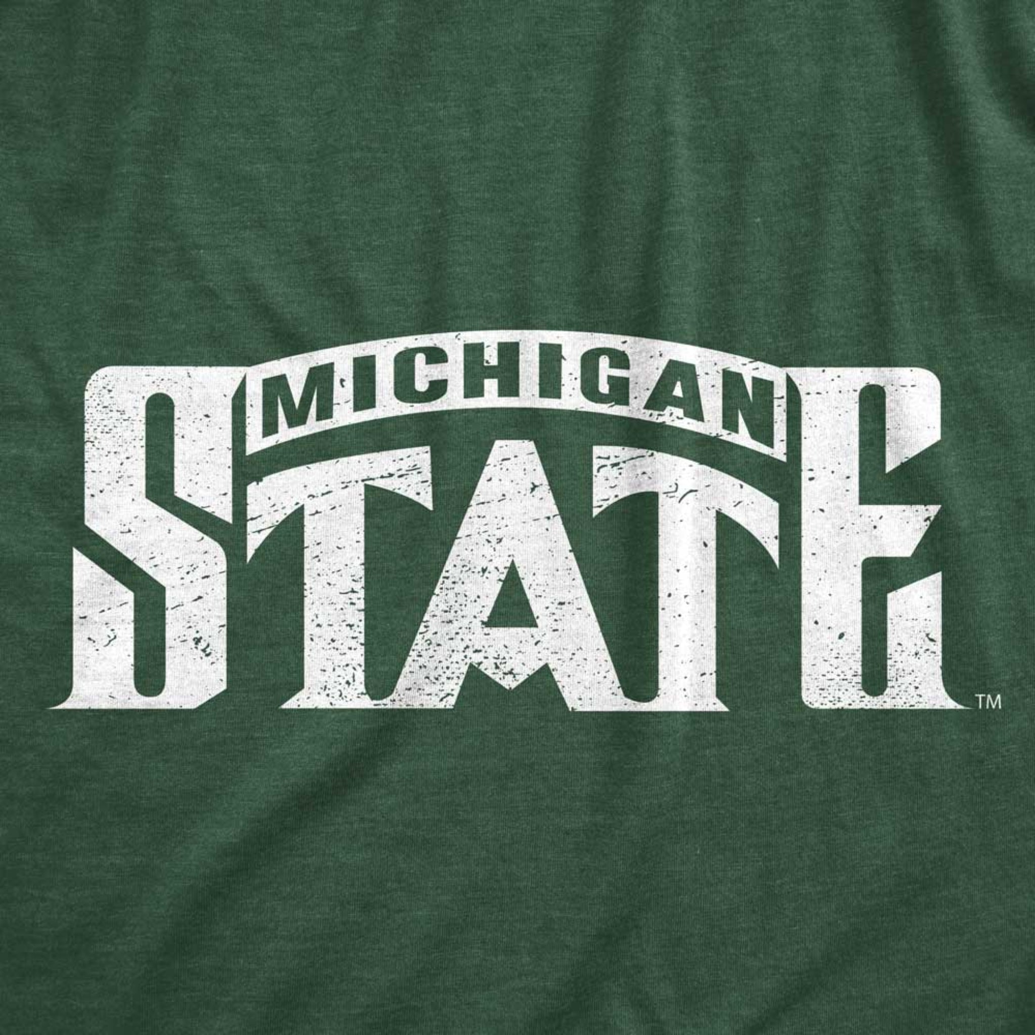 Close-up of a screenprinted white Michigan State logo on a green t-shirt.