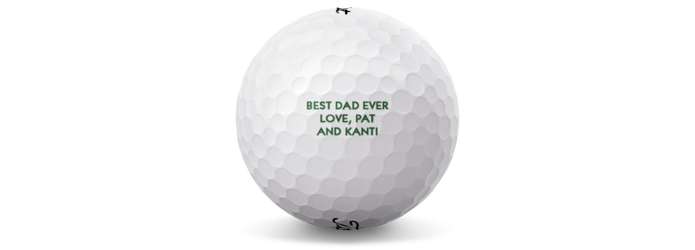 A white Titleist golf ball with green text personalized with a name and message.
