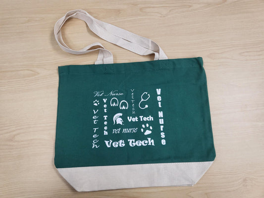 Green tote bag with white straps, a white bottom section, and white "Vet Tech" text and graphics related to veterinary technology and veterinary nursing.