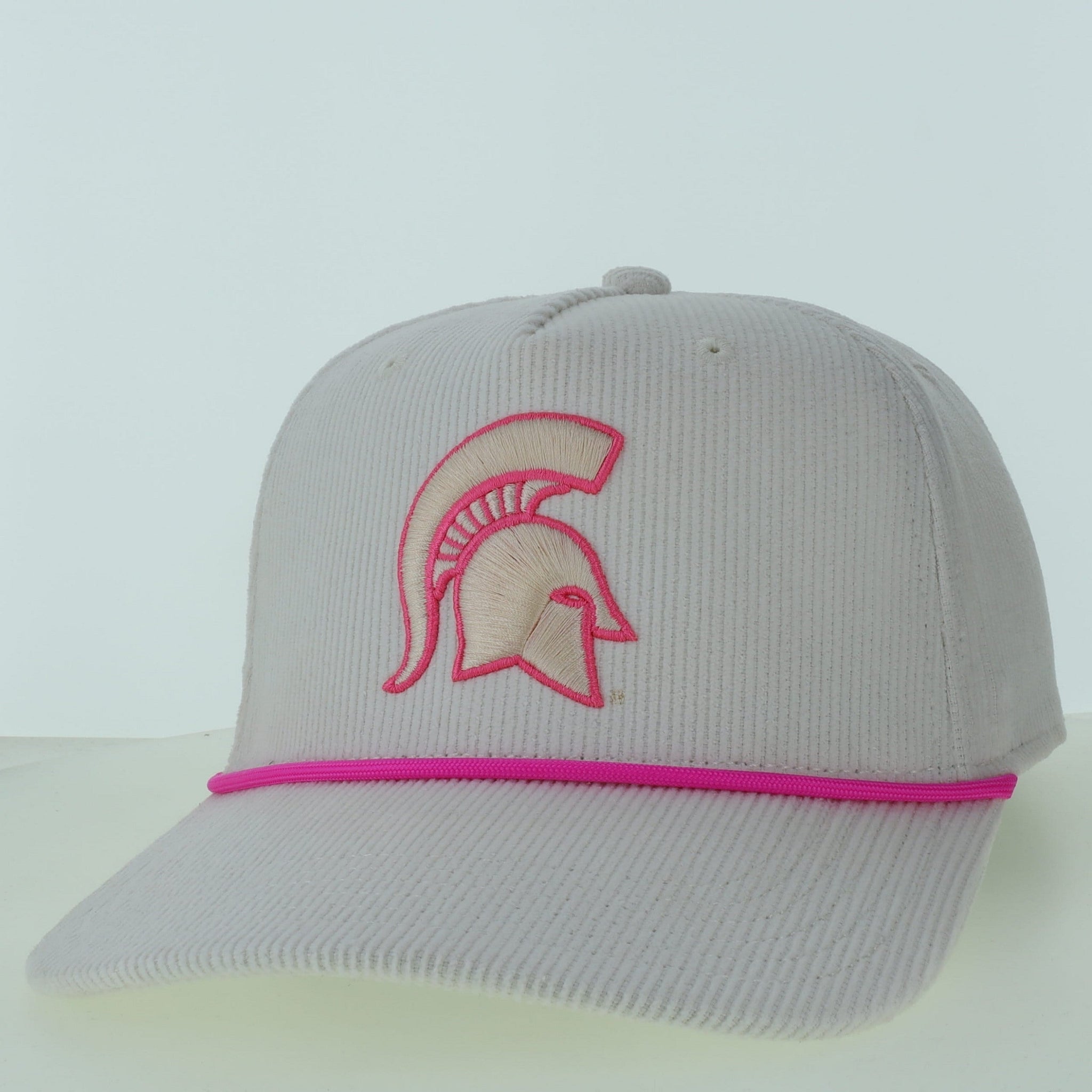A light gray corduroy Legacy Spartan Corduroy Hat with a slightly curved bill and pink cord across the front. The front features the Spartan Helmet logo outlined in pink.