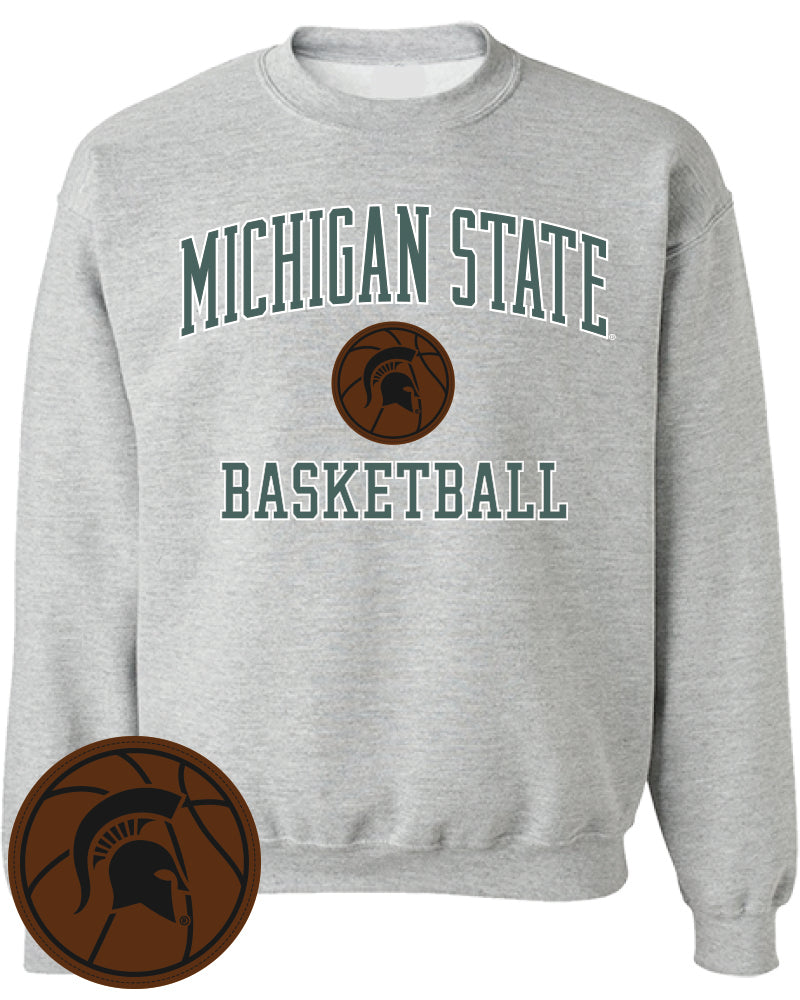 A gray crewneck sweatshirt with the words "Michigan State Basketball" in green around a brown basketball motif with a Spartan helmet logo in the center.