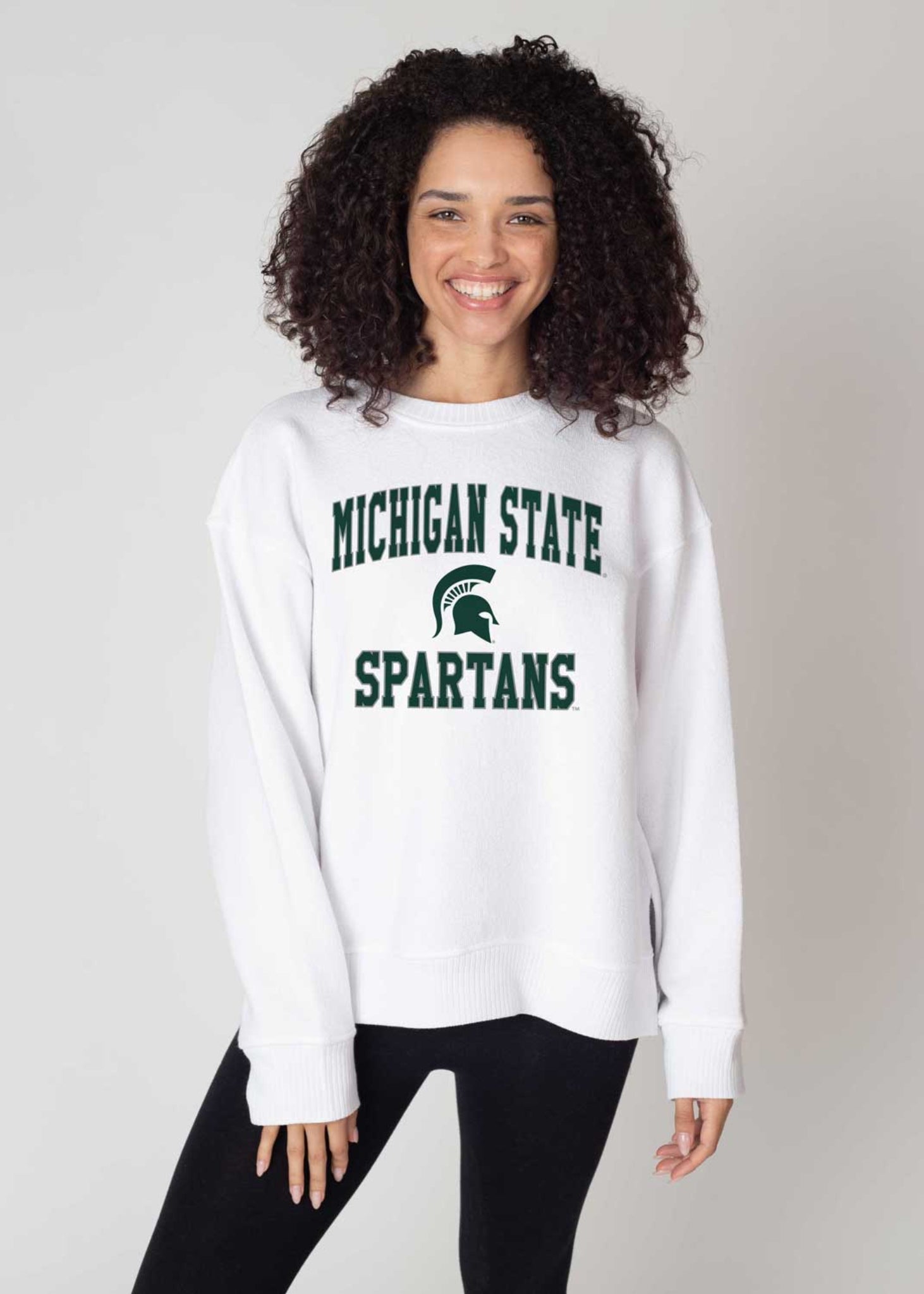 White sweatshirt featuring green 'MICHIGAN STATE SPARTANS' text and the Spartan helmet logo on the front.