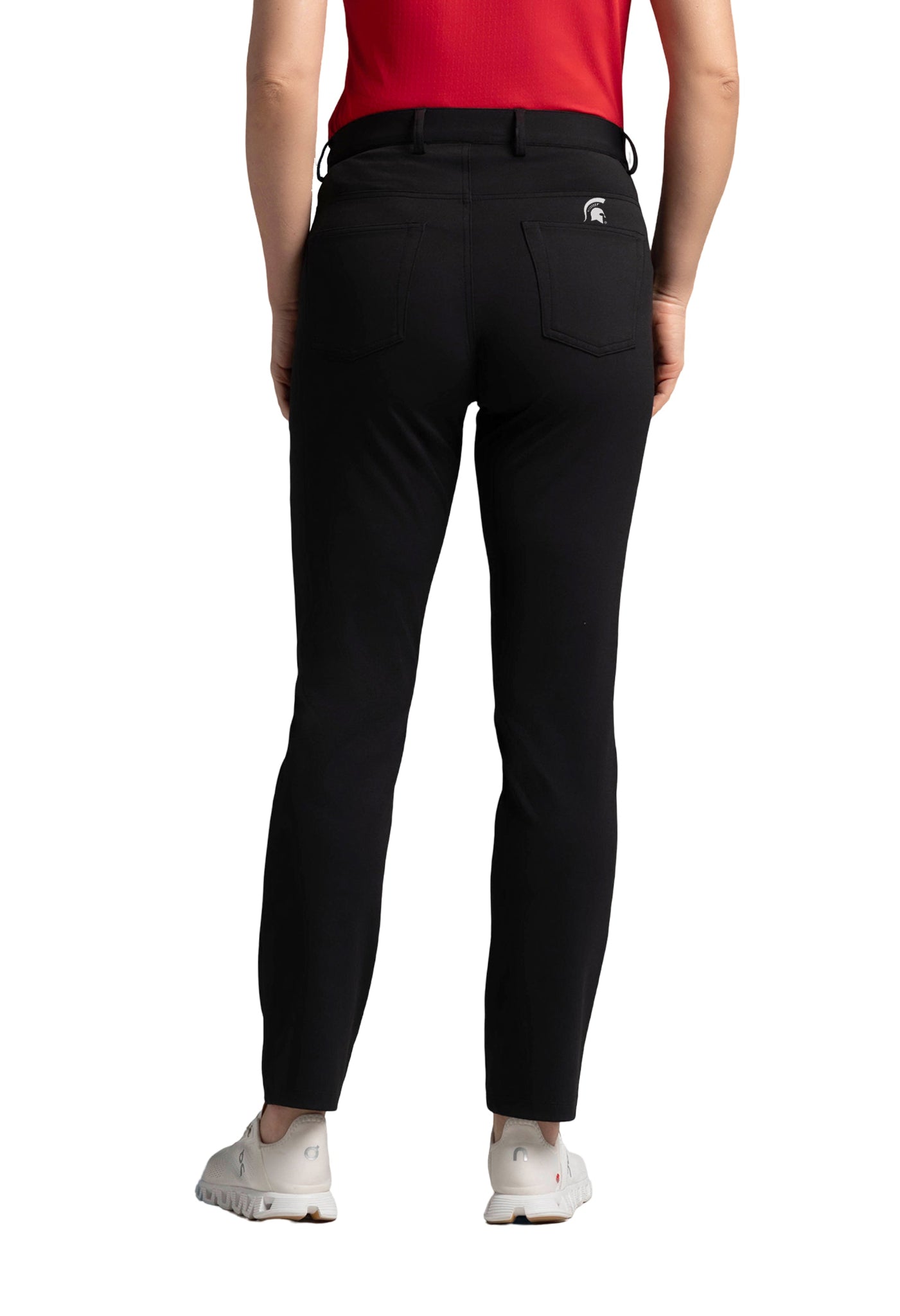 Back view of a person wearing a red shirt, black pants with back pockets, and white shoes. A small white Spartan Helmet logo is visible on the right pocket