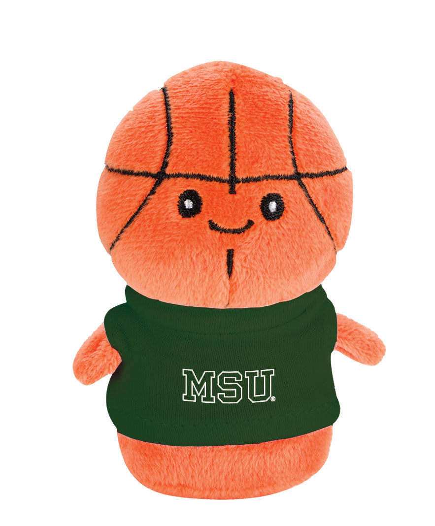 Stuffed mini basketball with a face and body. It is wearing a green T-shirt with a white MSU wordmark printed on the front.