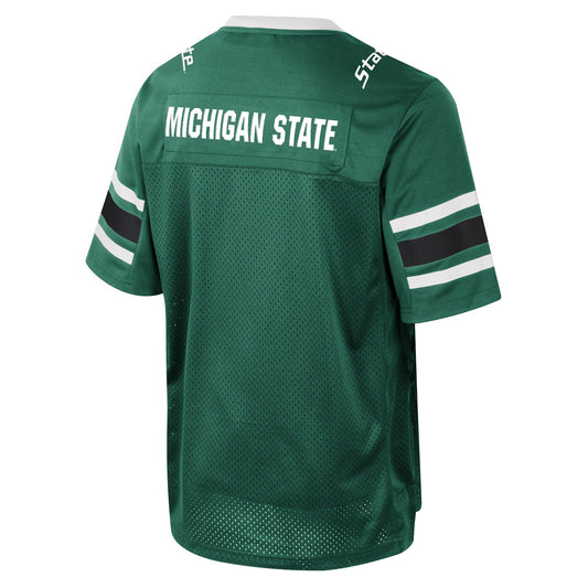 Back of a green and white football jersey with "Michigan State" printed in white on the upper back. On the sleeves there are two white stripes with a thicker black stripe in between them.