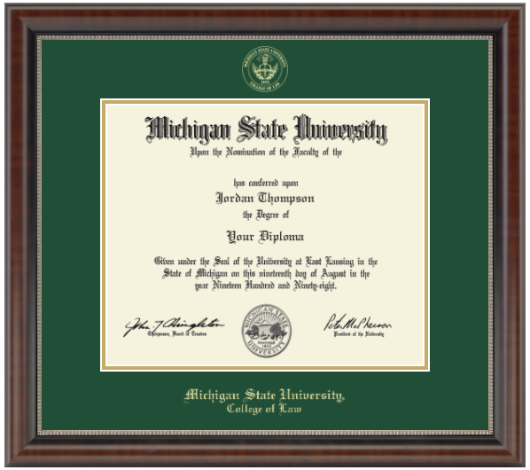 The diploma is displayed in a dark wood frame with green accents and a black matte. 'Michigan State University, College of Law' is printed in gold lettering at the bottom of the frame. Gold embossed Michigan State University seal.