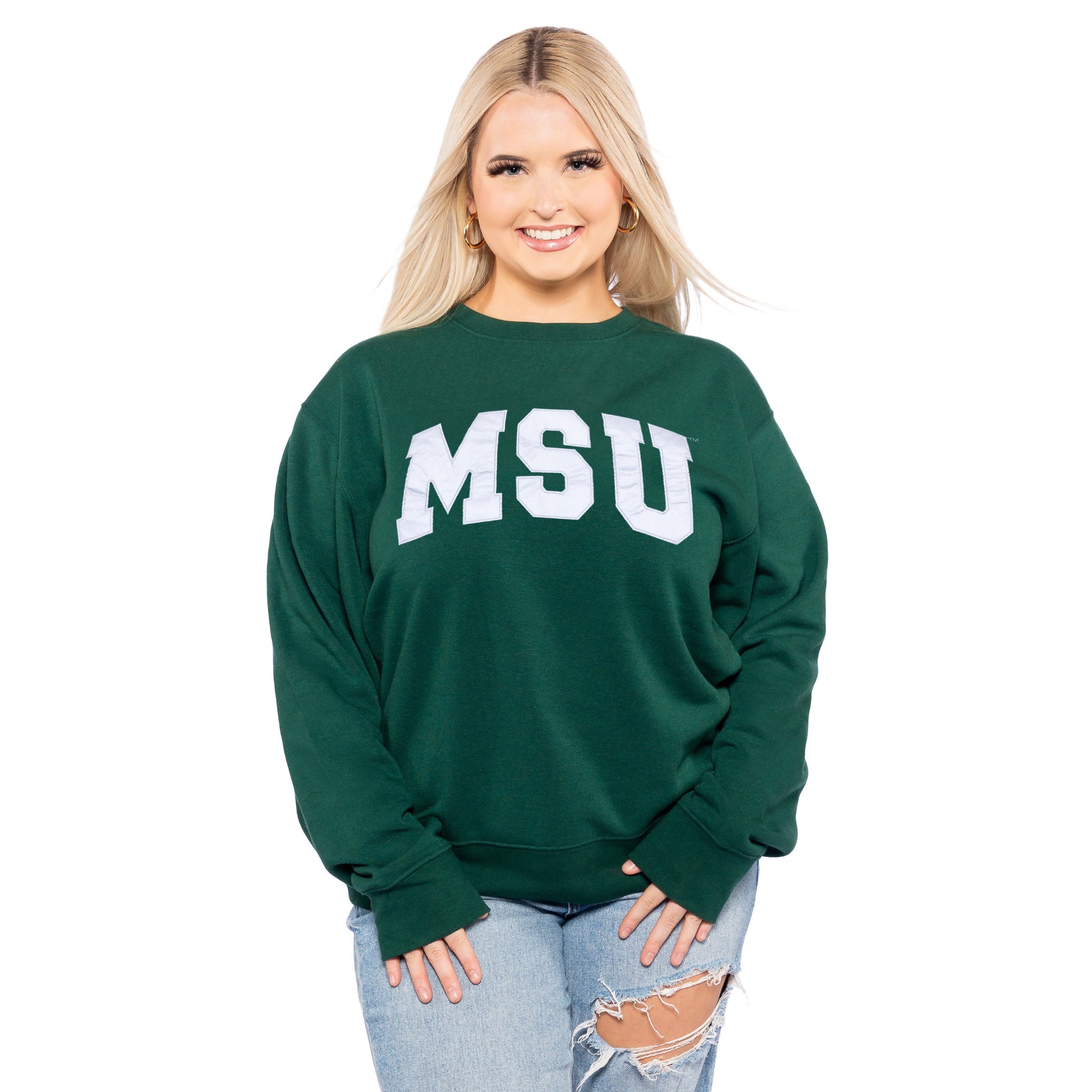 Person wearing a green crewneck sweatshirt with a silver metallic 'MSU' wordmark on the front. Shown on a white background.