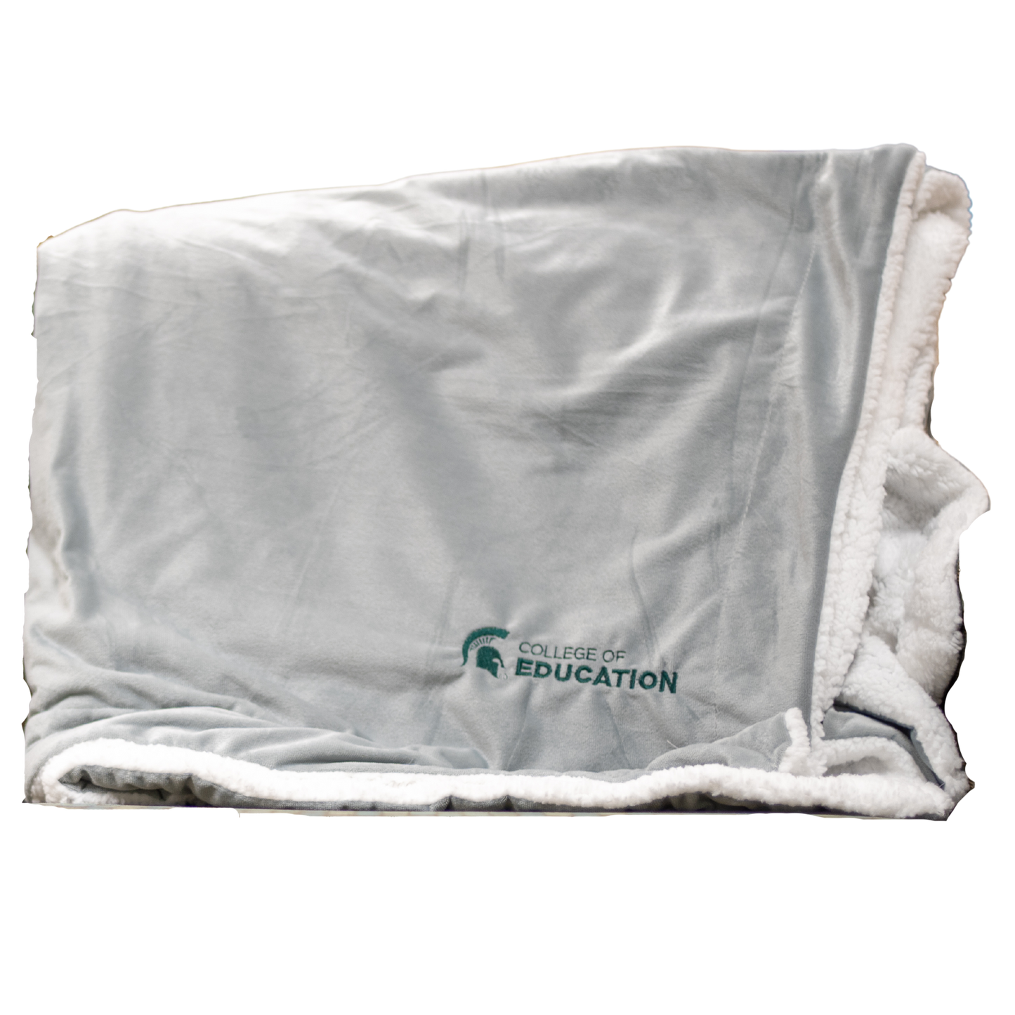 A gray plush blanket with a white, sherpa fleece lining. On the bottom right corner of the blanket, engraved in green, is an MSU Spartan Helmet logo with the words "College of Education."
