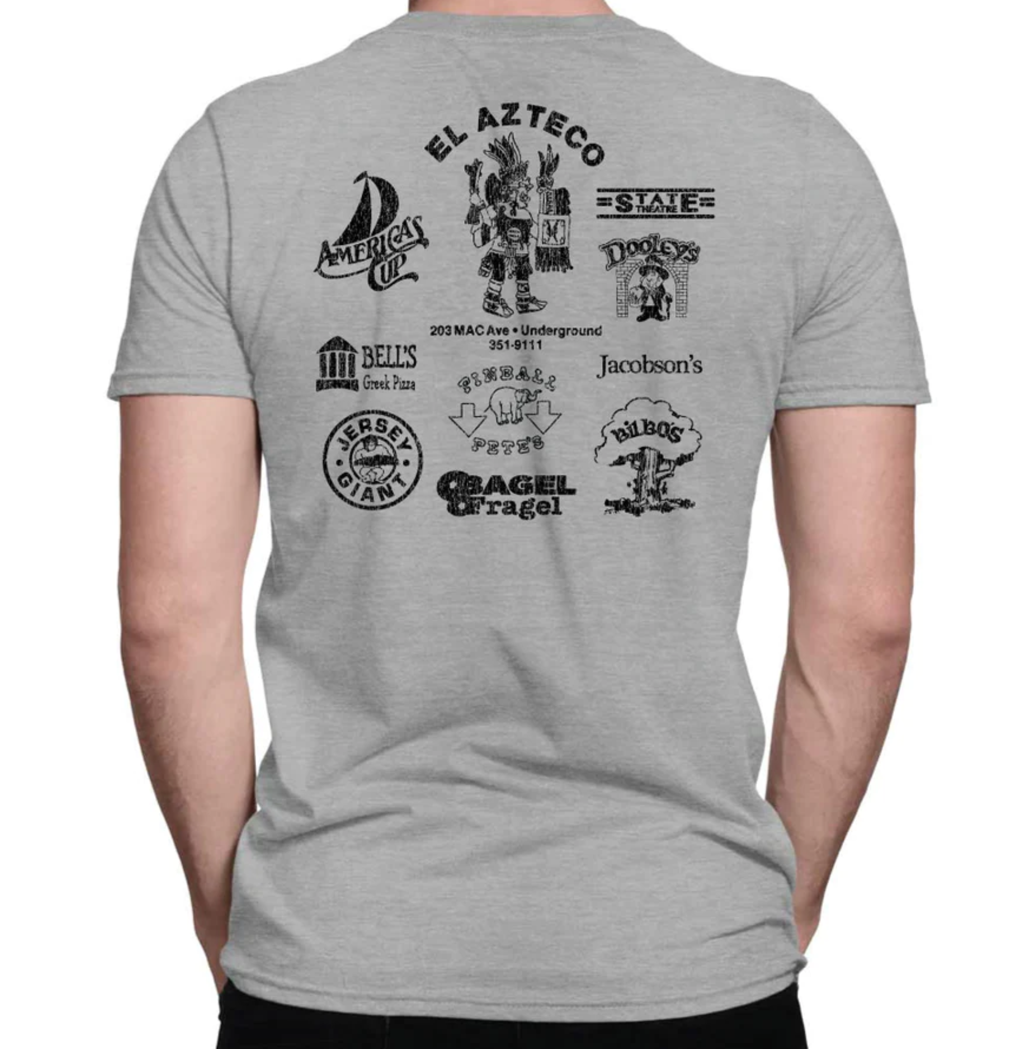 The back of a gray short sleeved shirt showing logos for America's Cup, El Azteco, the State Theatre, Dooley's, Bell's Greek Pizza, Pinball Pete's, Jacobsen's, Bilbo's, Bagel Fragel, and Jersey Giant.