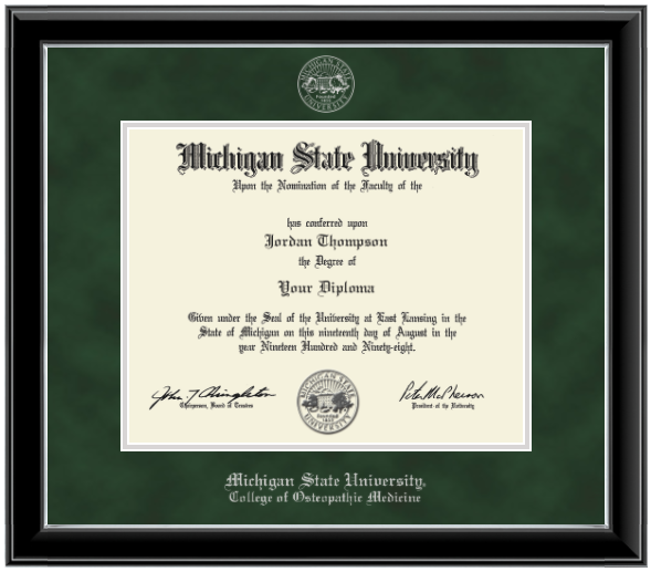 Framed Michigan State University diploma in a black glossy frame with a silver inner edge. The matte is dark green, featuring the university seal at the top center and 'Michigan State University' written in silver at the bottom center.