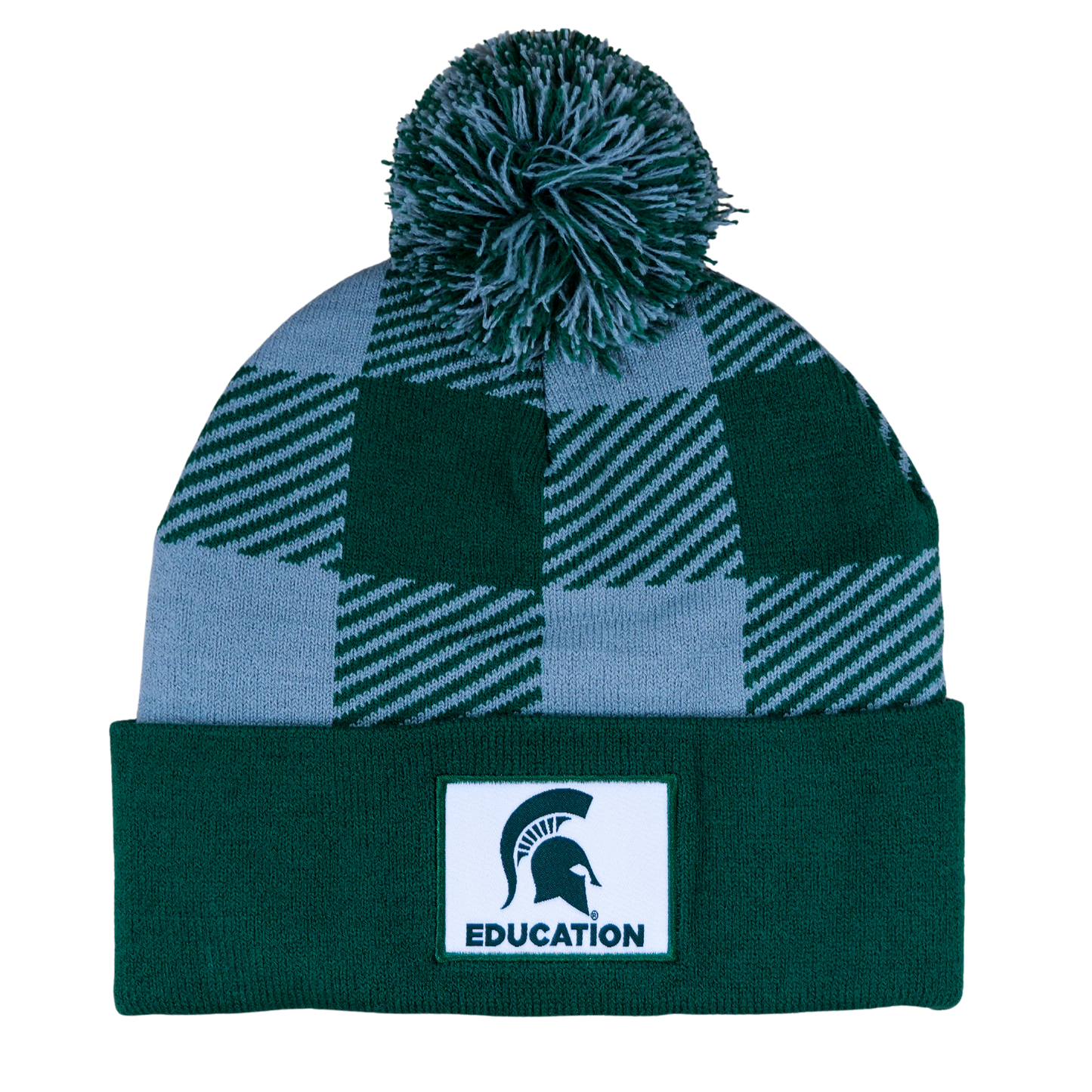 A green and gray plaid beanie with a matching pom. The cuff of the hat is an MSU green with a white sewn patch that features the Spartan Helmet logo and "Education" written in green.