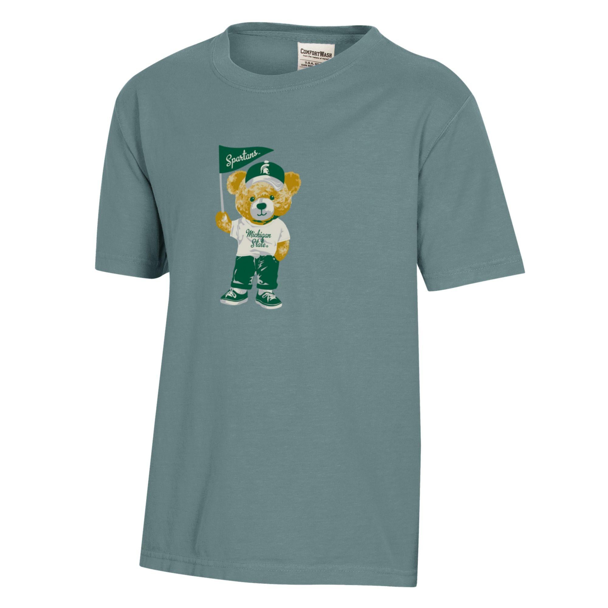 Blue T-shirt with a gold teddy bear graphic, wearing a white T-shirt with "Michigan State" written on it, green pants, and green and white shoes.