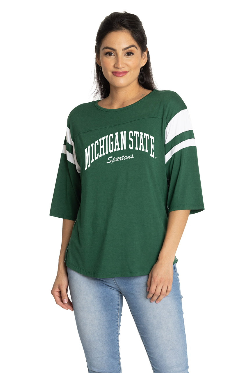 A model wearing a green Michigan State Spartans three-quarter sleeve shirt.