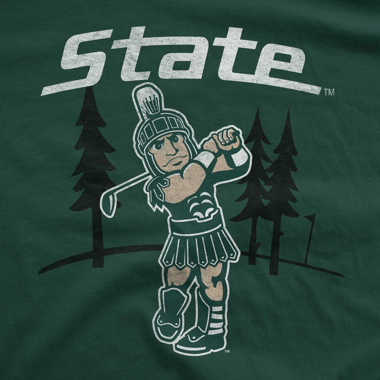 A green t-shirt with a white "State" wordmark above a graphic of Sparty golfing in front of some pine trees.