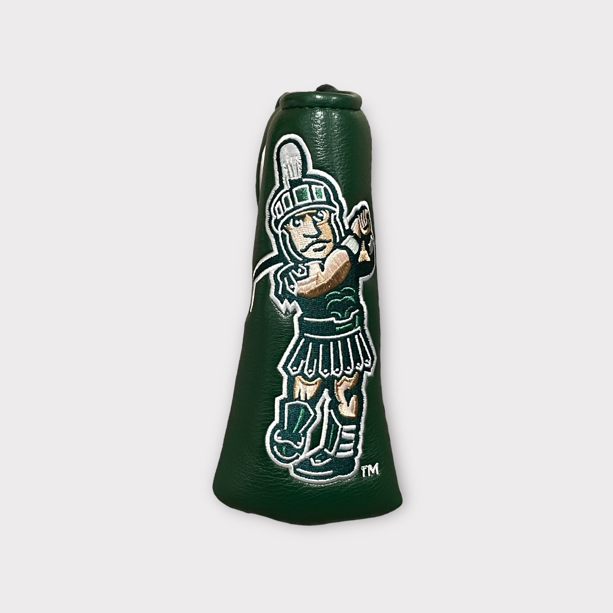 A green leather head cover featuring an embroidered golfing Sparty logo.