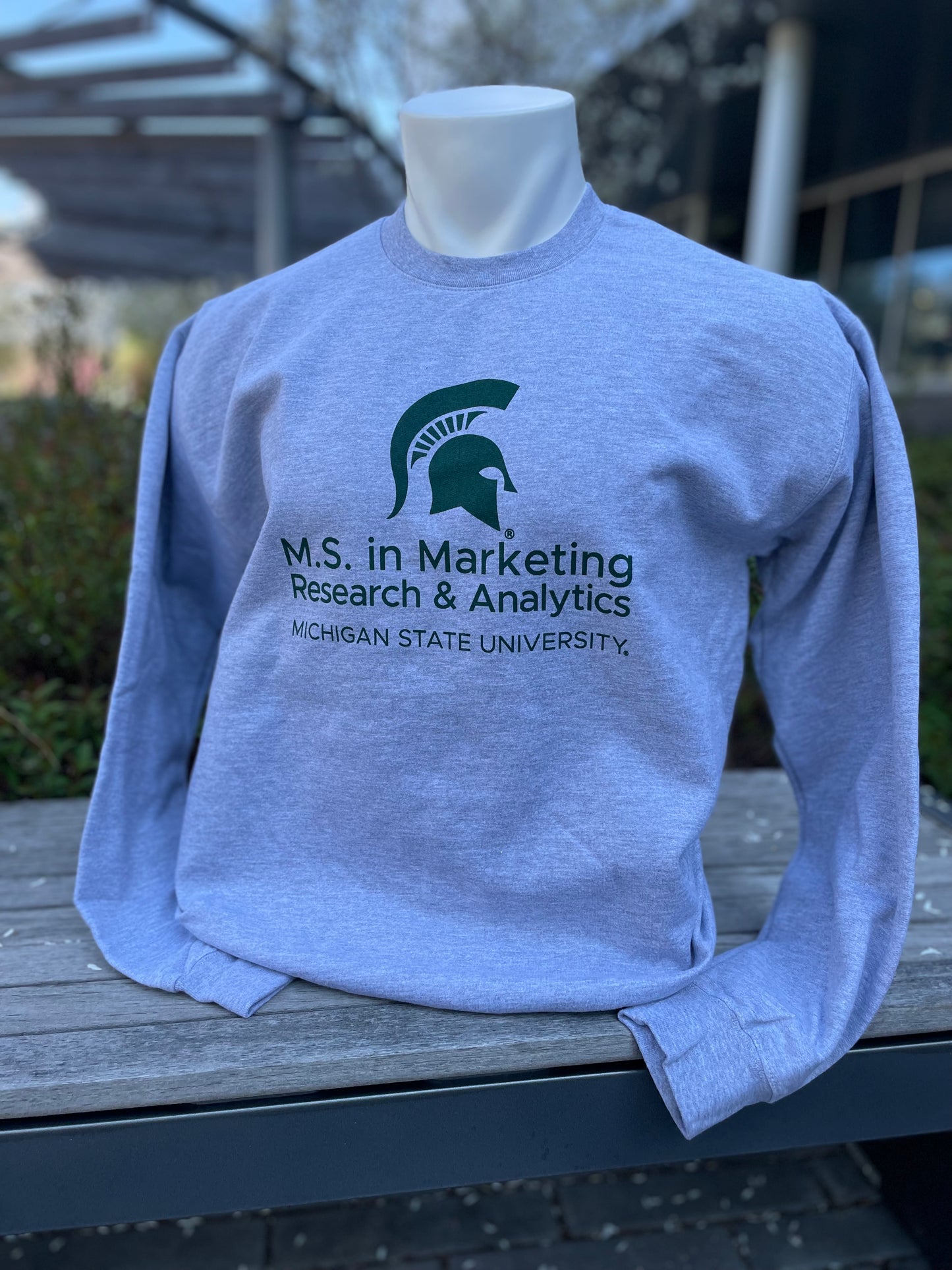 Gray crewneck sweatshirt with the M.S. in Marketing Research & Analytics Michigan State University logo printed in green on the front.