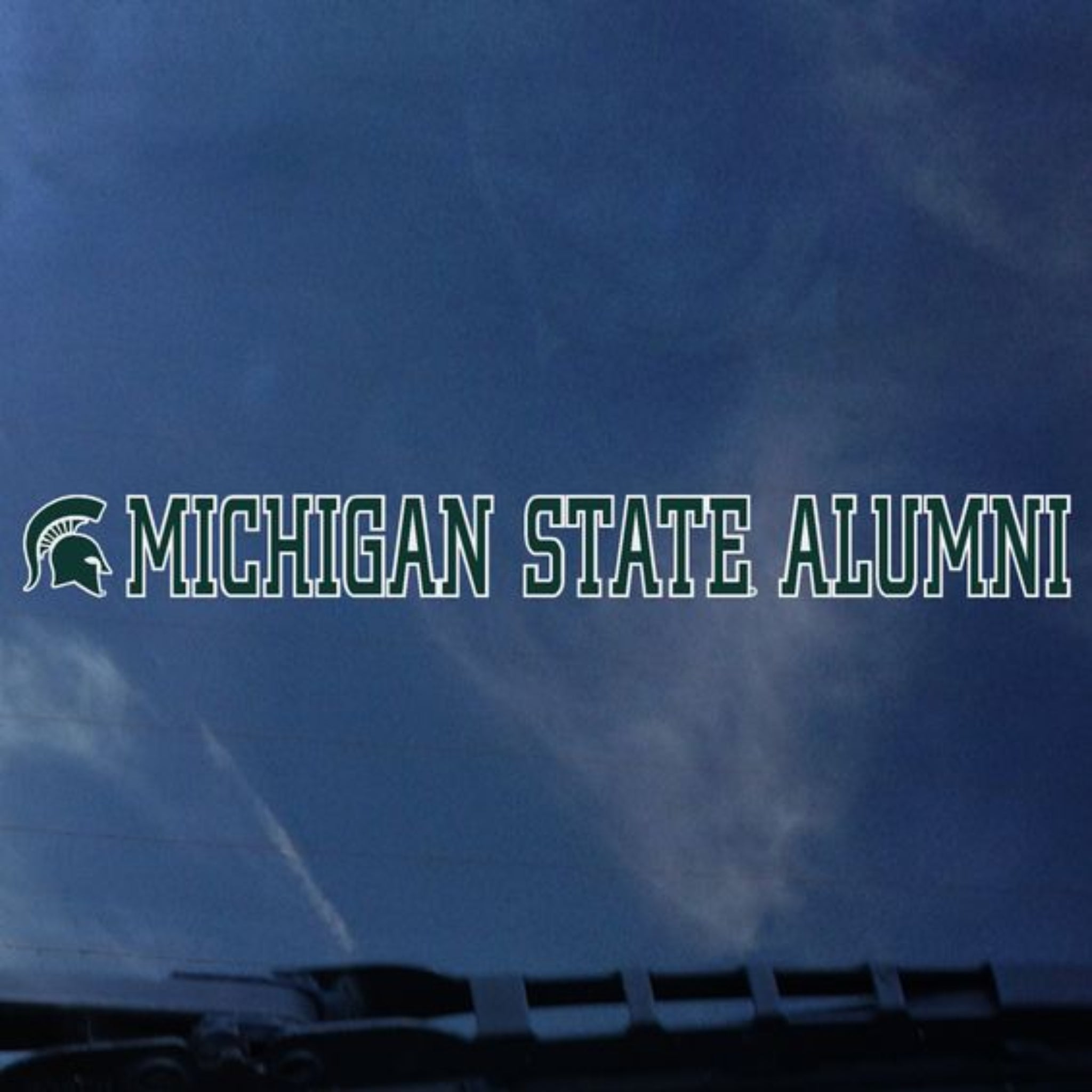 Car Decal that starts with a Spartan Helmet and is followed by 'Michigan State Alumni' all in green and ouined in white.