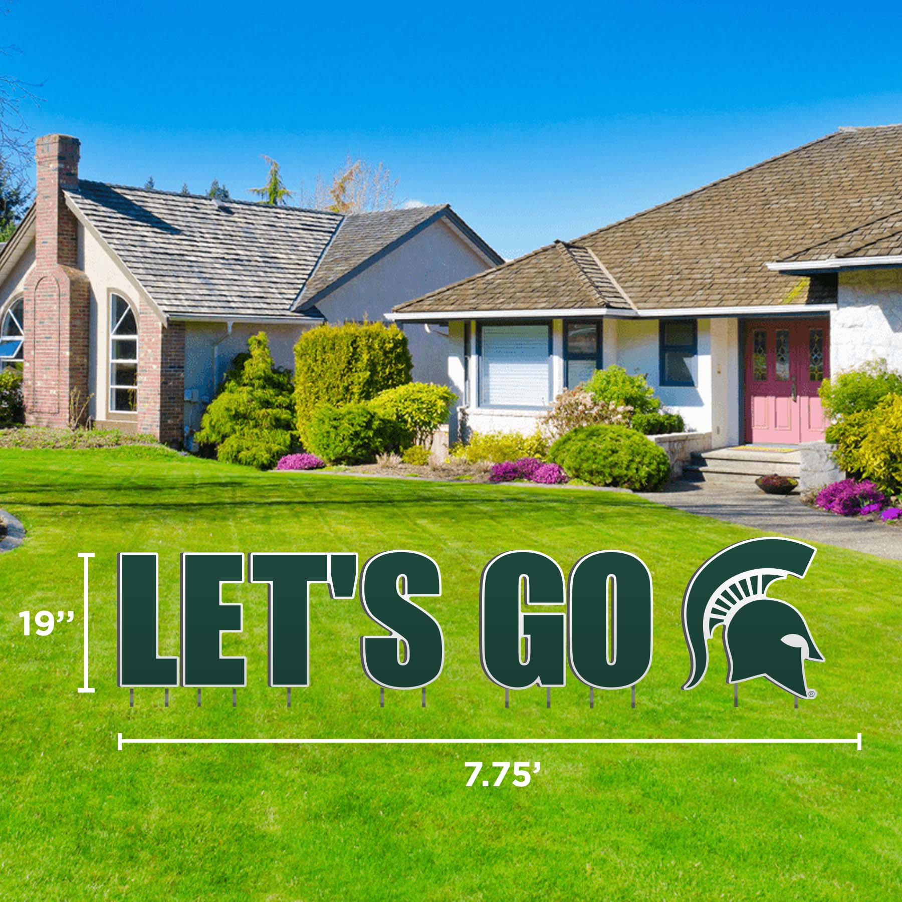 A lawn display that says 'LET'S GO' with the partan helmet at the end in green outlined in white, set against a residential background.