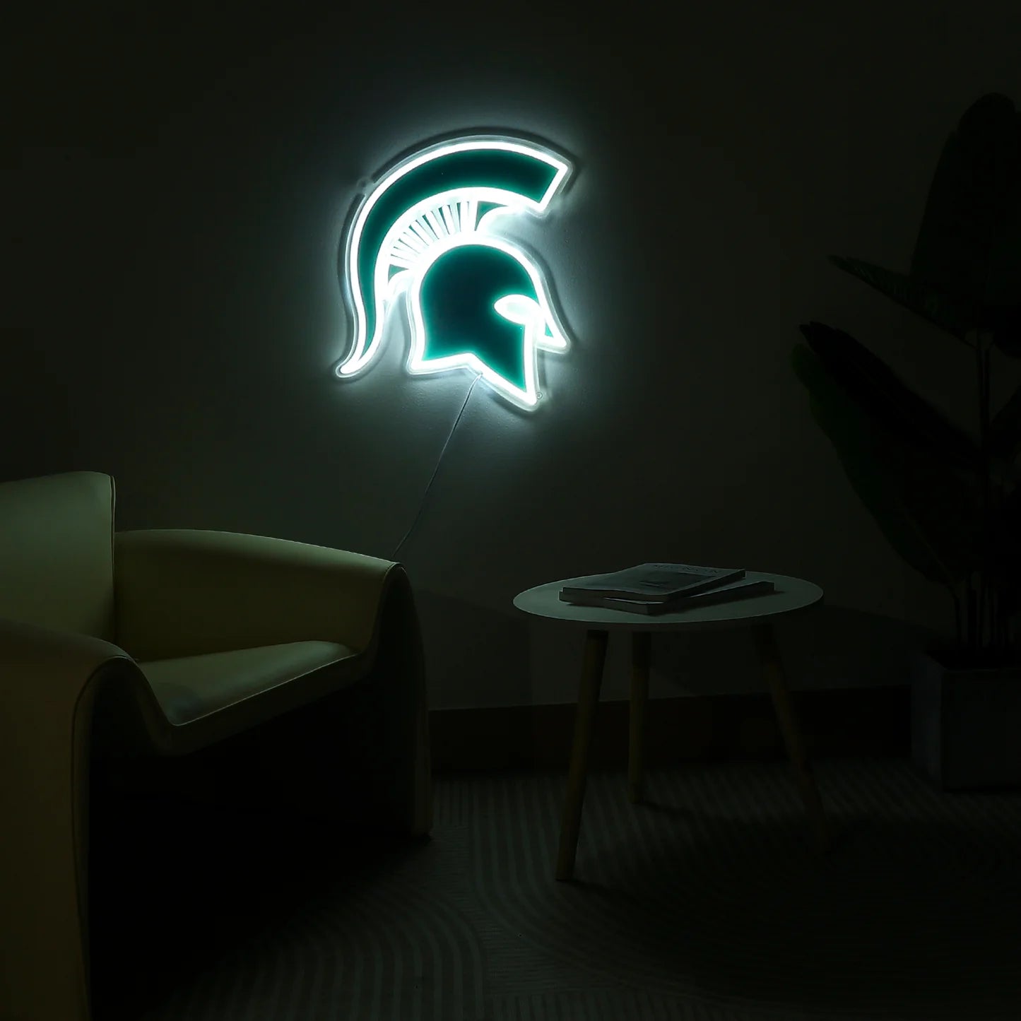 LED Spartan helmet wall sign shown lit up in a dimly lit room.