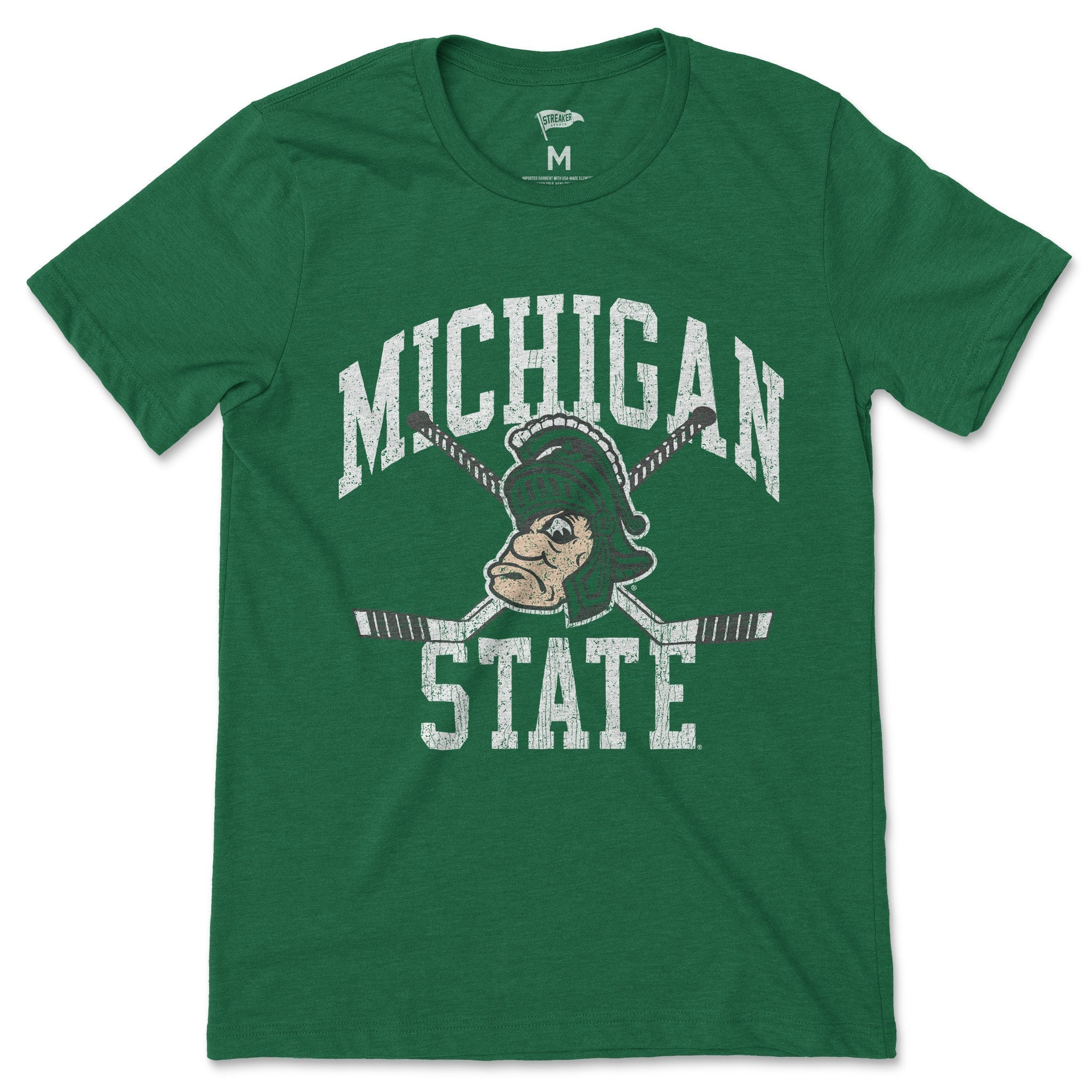 A green t-shirt with a Gruff Sparty logo over crossed hockey sticks between the words "Michigan State" in white.