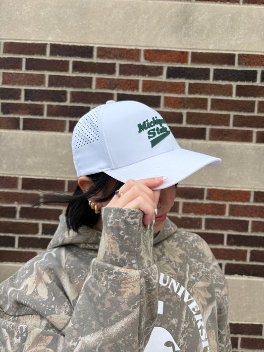 Side view of Michigan State Hockey Brand Bills Performance hat. Highlighting laser perforated panels and curved bill. On front panel in Green PVC it reads, "Michigan State."