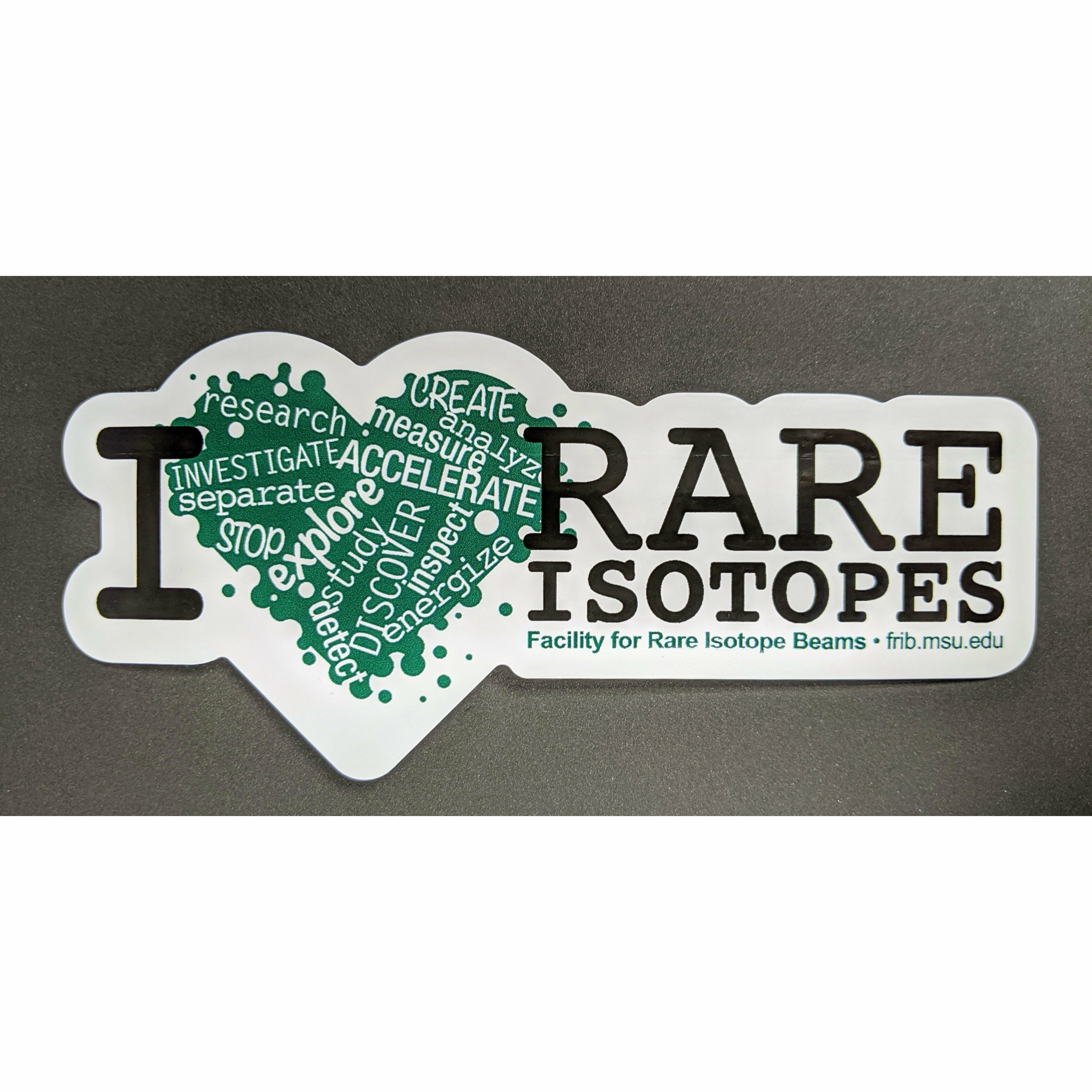 Green heart with a variety of words cutout in white such as accelerate, explore, and discover. To the left is a large black serif letter I, with two lines of the same font on the right-hand side spelling out "rare isotopes." Below the isotopes line, green text reads "Facility for Rare Isotope Beams, FRIB.MSU.EDU." The sticker has a thick white border that follows the shape of the graphics and text.