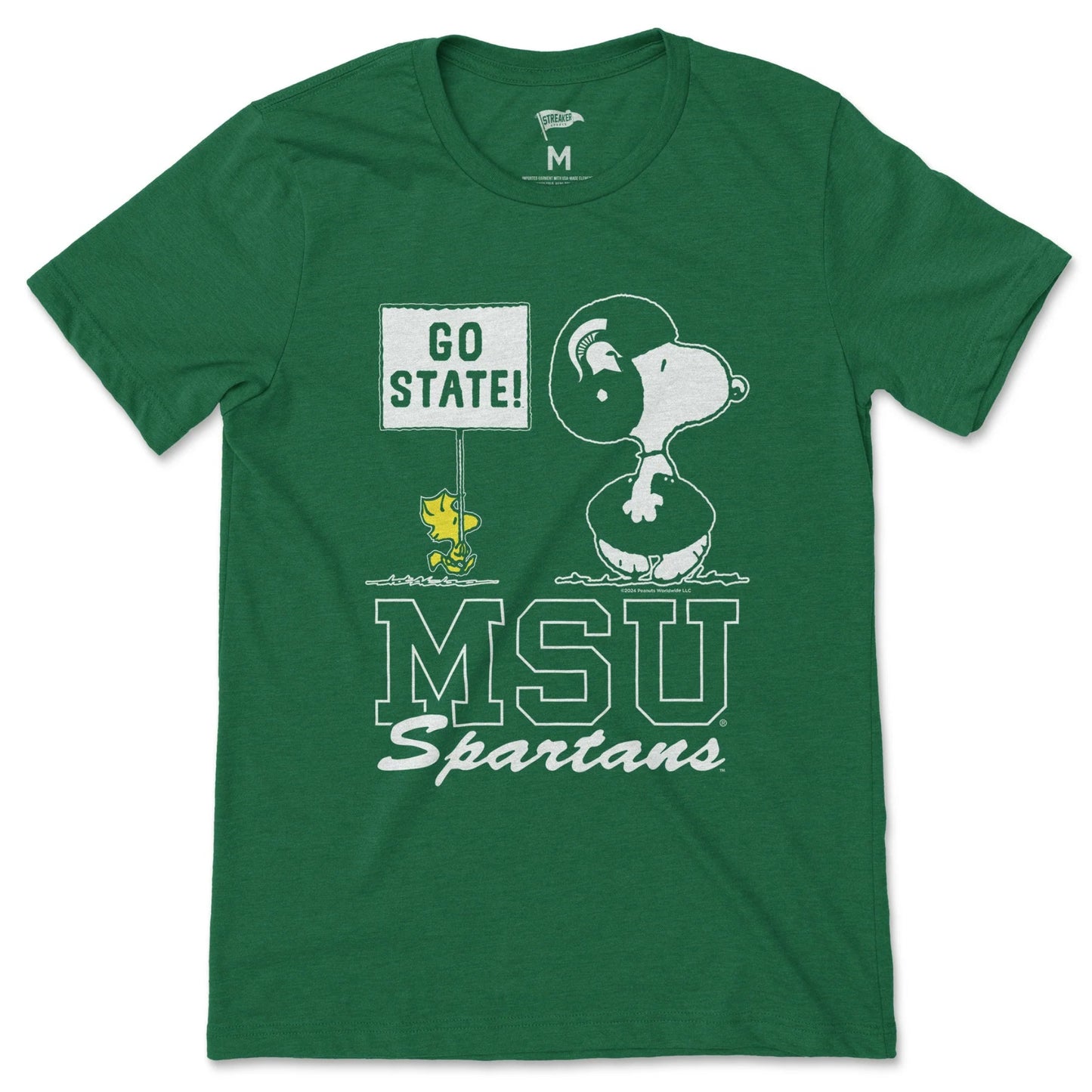 Green Michigan State Spartans T-shirt featuring Snoopy wearing a Spartan helmet, Woodstock holding a “GO STATE!” sign, and large “MSU Spartans” lettering.