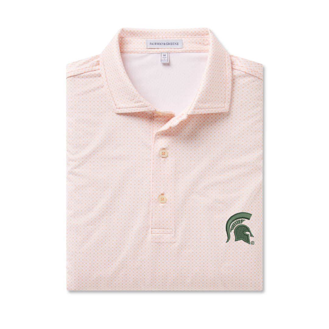 Light pink polo folded with a spotted design, an off white three-button placket, and a dark green Spartan Helmet logo embroidered on the upper left chest. Shown on a white background.