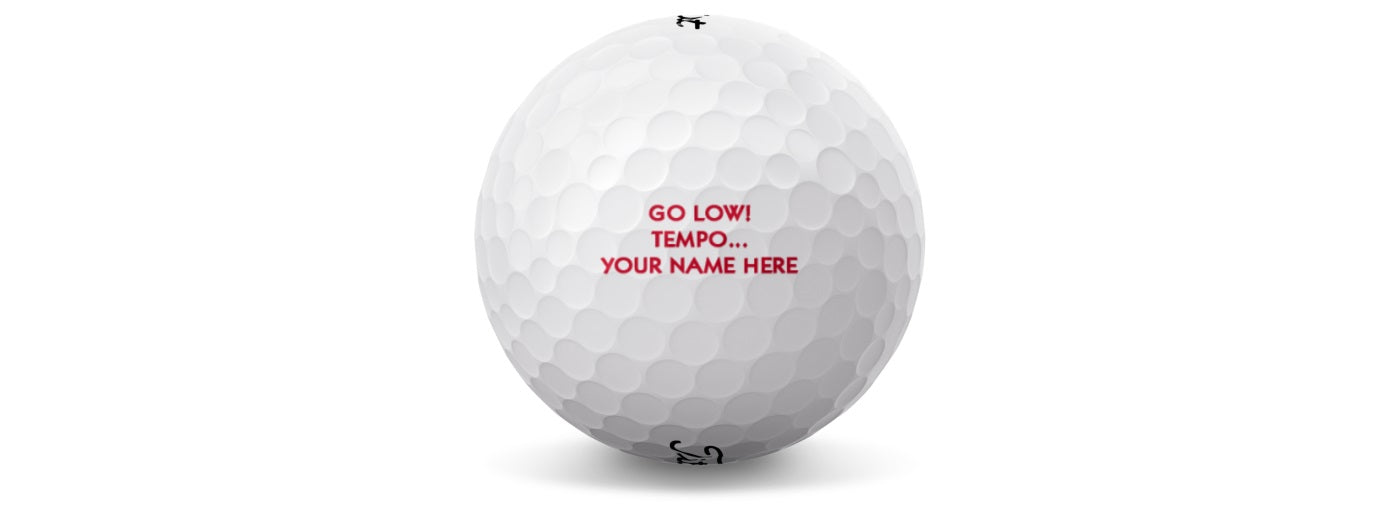 A white Titleist golf ball with red text personalized with a name and message.