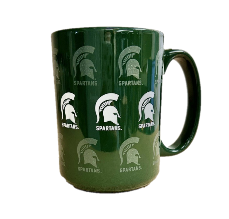 A green ceramic mug with white and frosted screen print graphics of Spartan helmets all over.