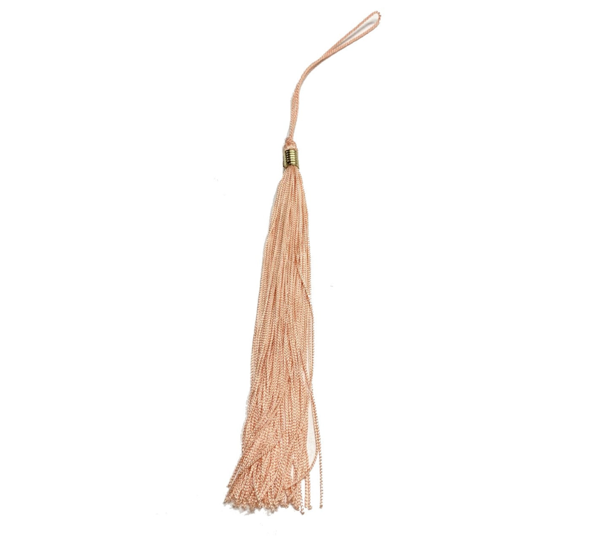 A salmon colored graduation tassel.