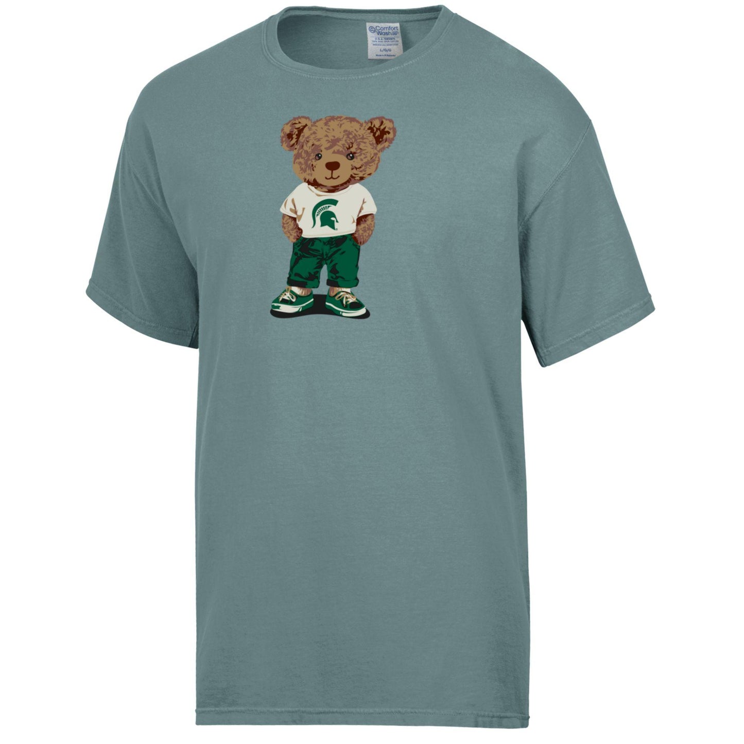 Blue green T-shirt with a brown teddy bear graphic, wearing a white T-shirt with a green Spartan Helmet logo on it, green pants, and green and white shoes.