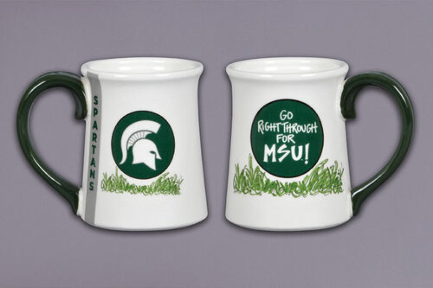 A ceramic mug with Michigan State colors and symbols, featuring text "Go Right Through For MSU" in the middle and a vertical "Spartans" on the side, and an illustration of a Spartan Helmet.