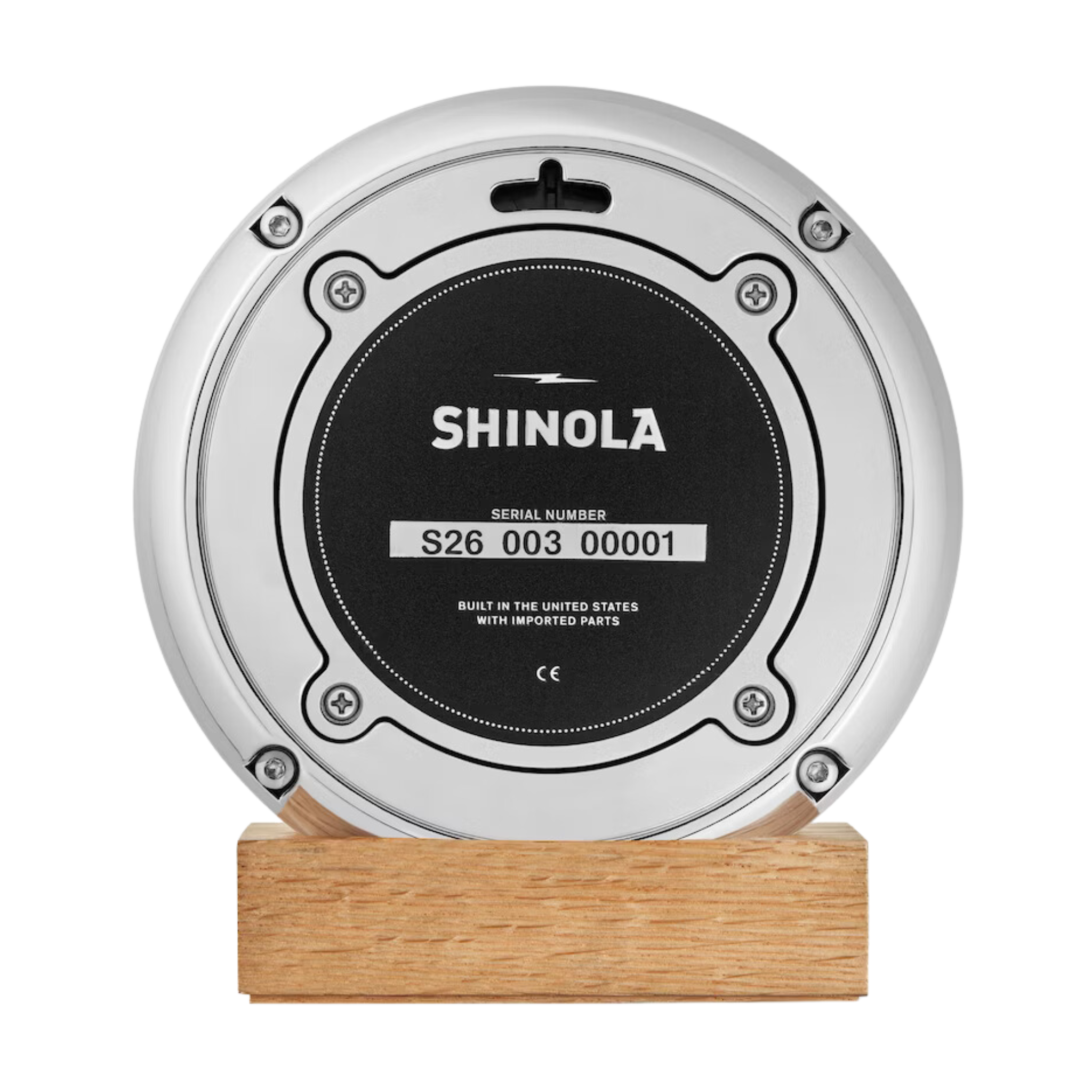 Shinola desk clock case back on a wooden stand.