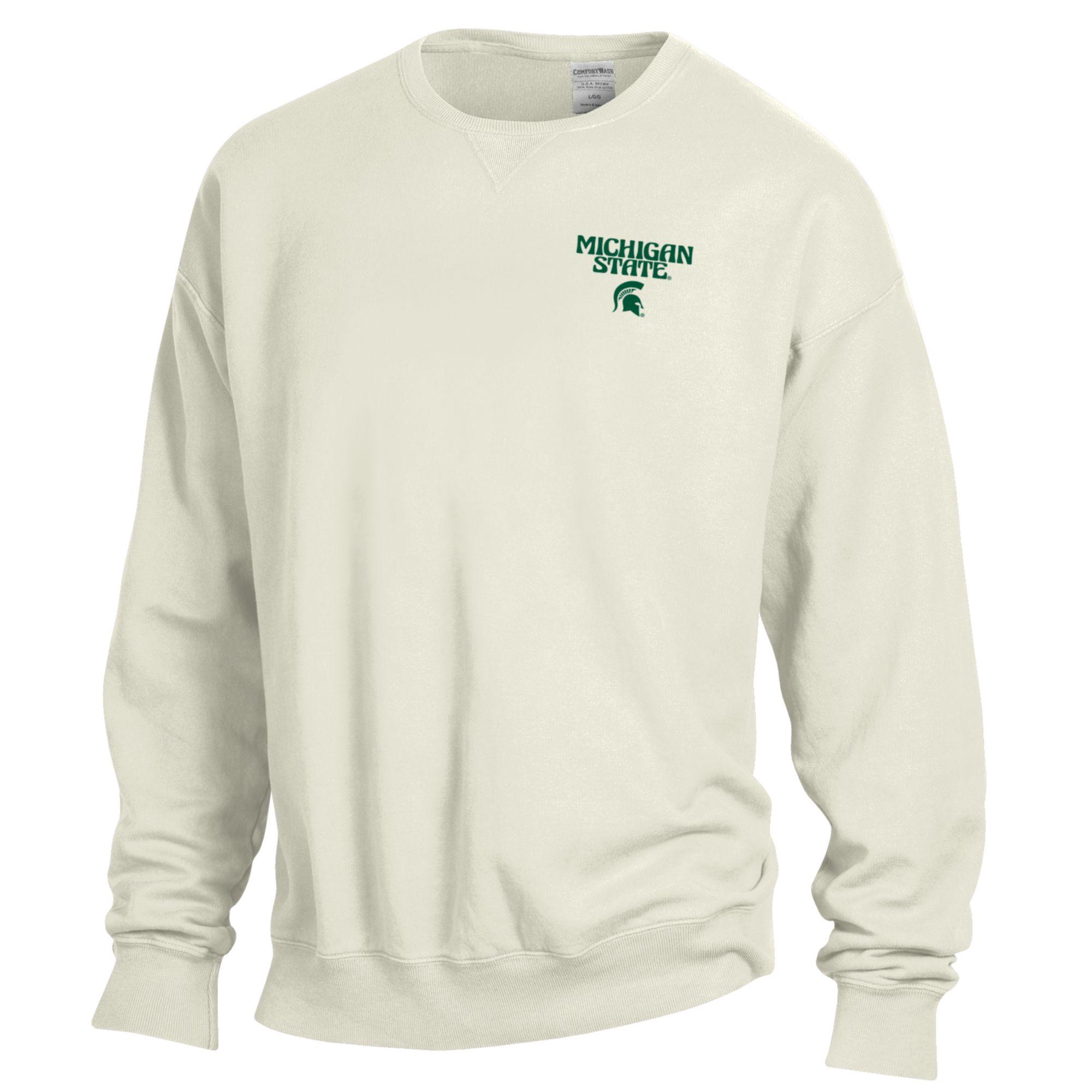 The front of a white crewneck that reads "Michigan State" in a groovy font above a green Spartan helmet logo on the upper left chest.