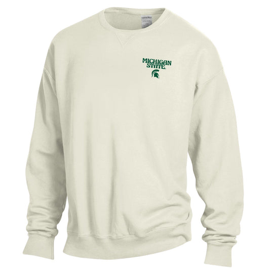 The front of a white crewneck that reads "Michigan State" in a groovy font above a green Spartan helmet logo on the upper left chest.