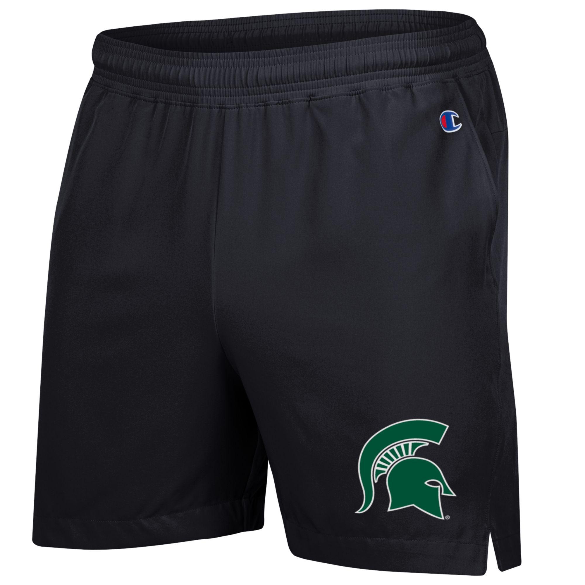 A black pair of shorts with a green Spartan helmet logo on the left leg.