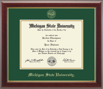 The diploma is mounted on a black matte background with a gold-trimmed frame. With gold Michigan State University seal at top of Matte. At bottom of matte in gold letters is 'Michigan State University'.