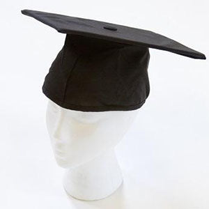 A black graduation cap on a mannequin head.