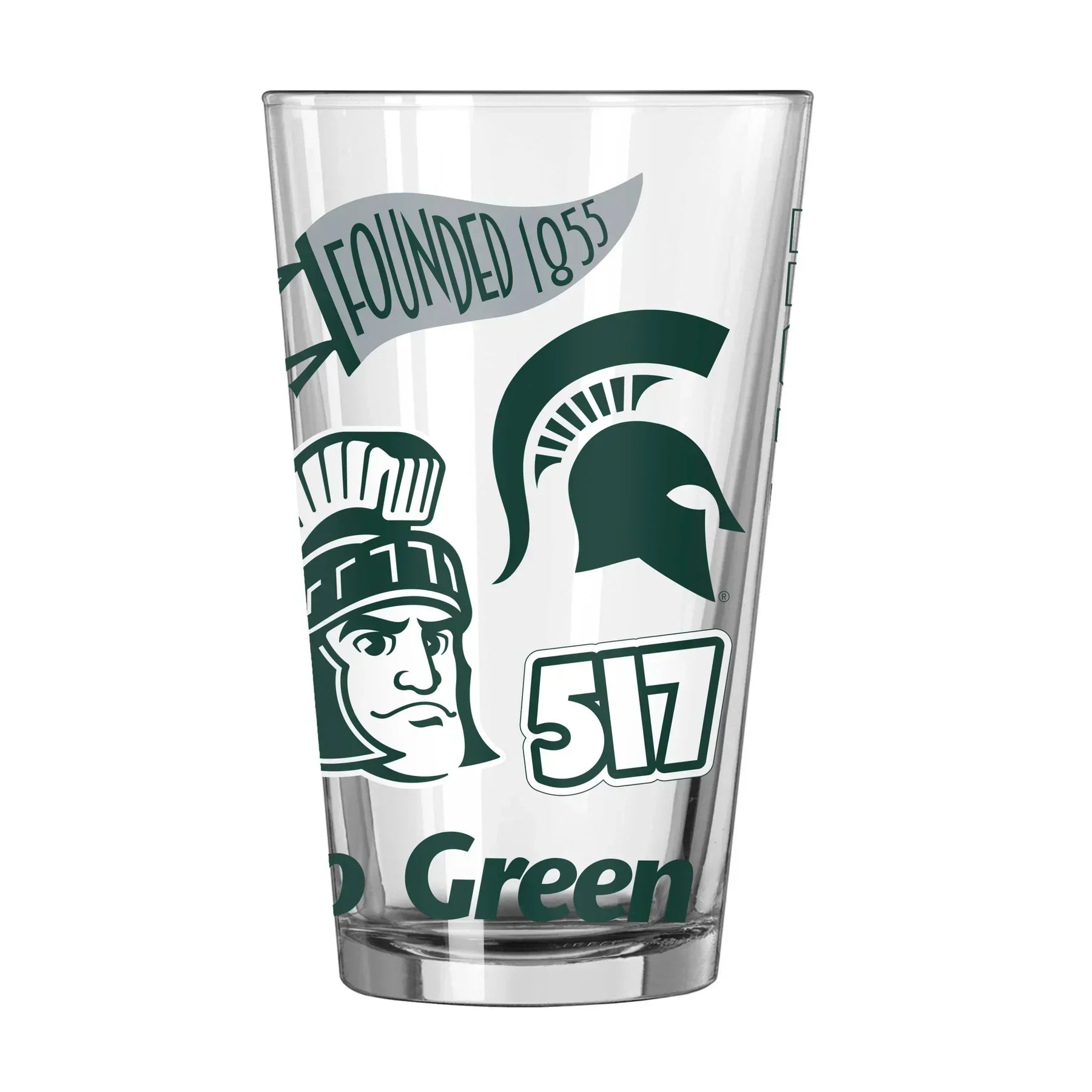 A pint glass with green and white designs including a flag, a Spartan helmet, Sparty, 517, and "Go Green."