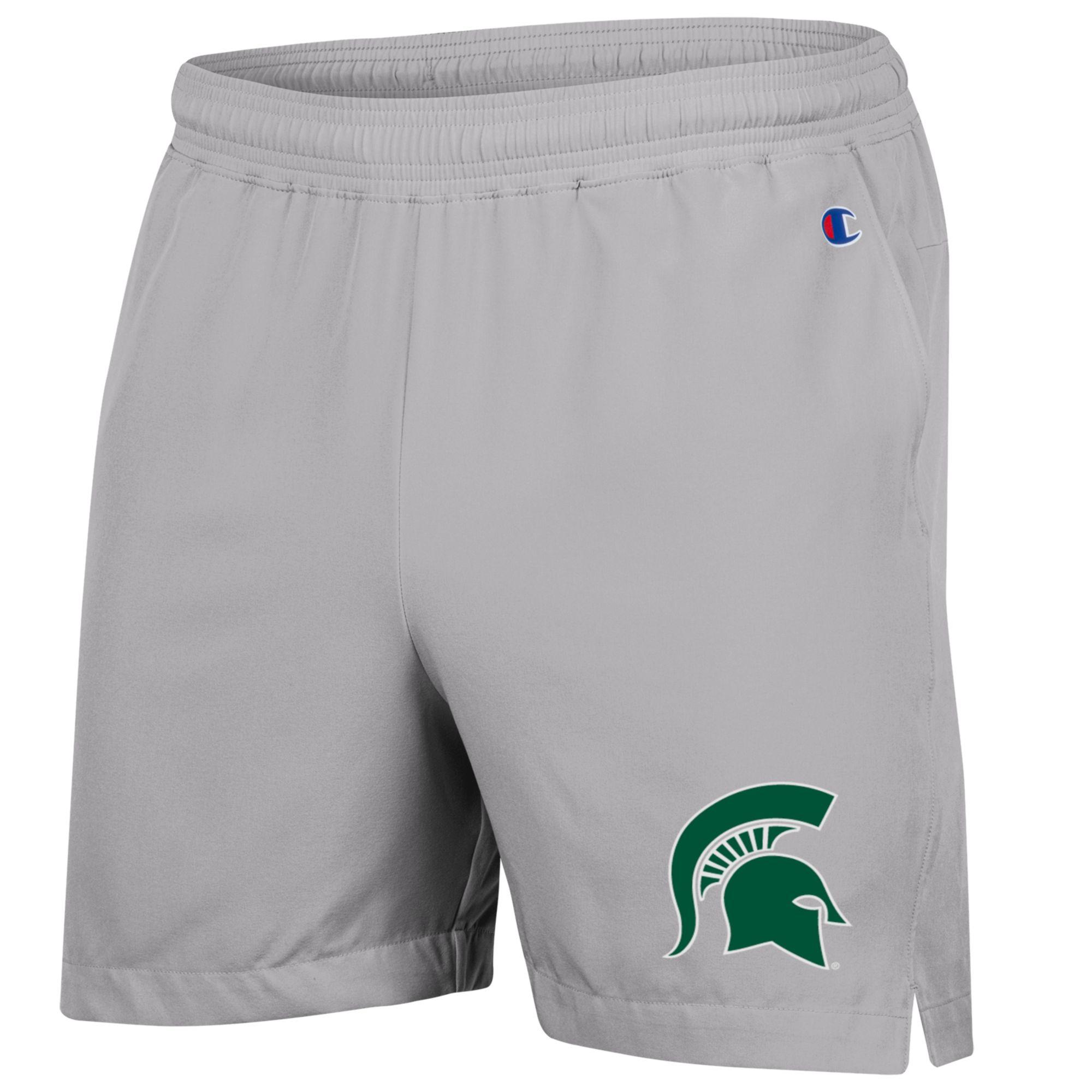 A gray pair of shorts with a green Spartan helmet logo on the left leg.