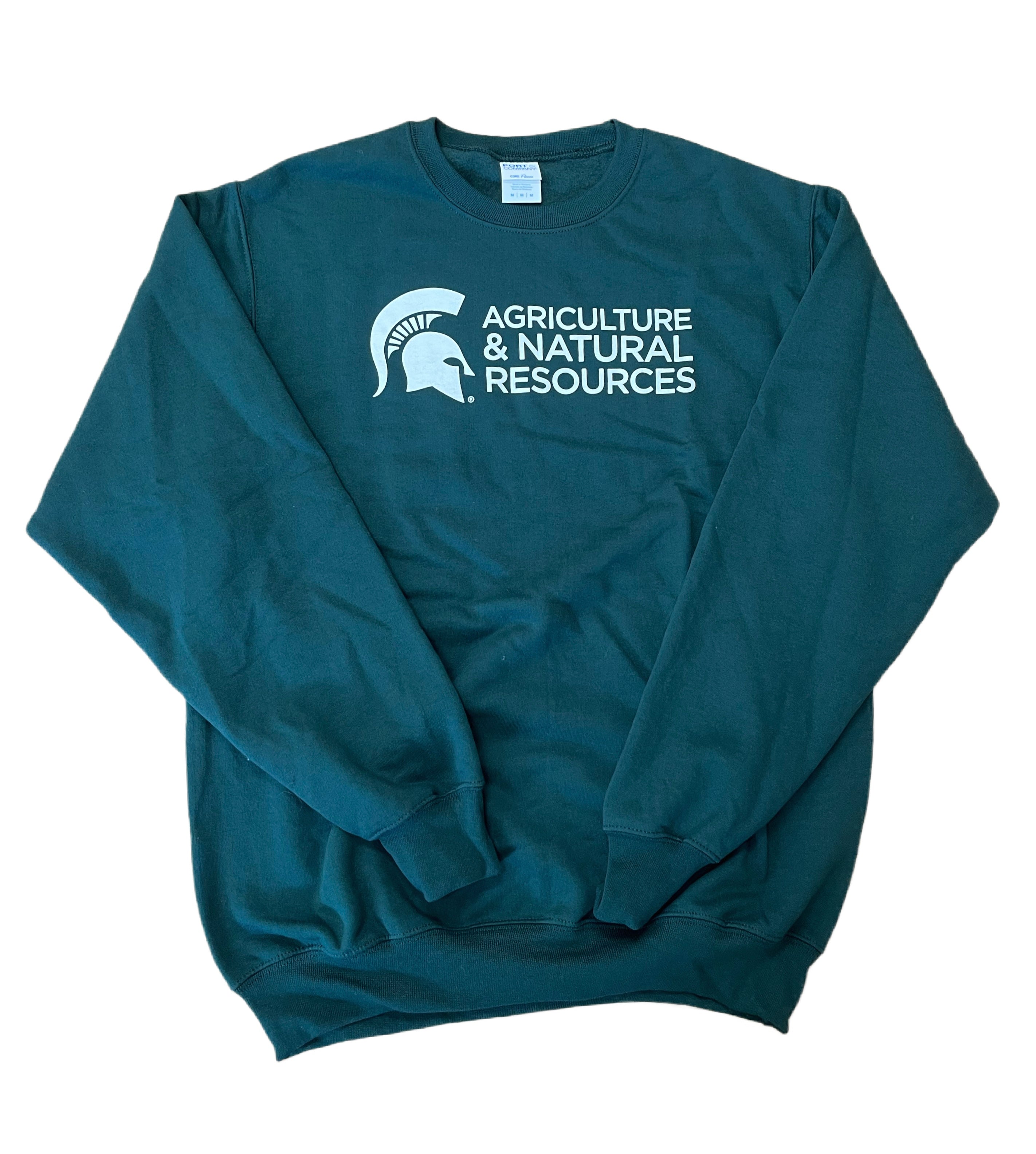 Forest green crewneck sweatshirt with long sleeves. Across the center chest is all-caps white text on three lines reading “Agriculture & Natural Resources.” To the left of the text is a white Spartan helmet.
