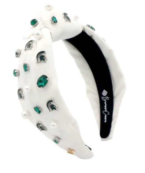 Green headband with pearls, rhinestones, and Spartan helmet charms; 'Brianna Cannon' label inside.