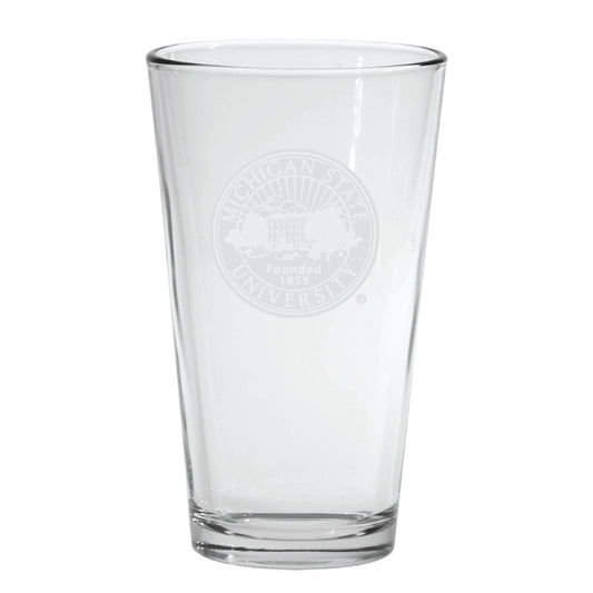 Clear Michigan State University pint glass featuring a frosted etched university seal with the text “Michigan State University” and “Founded 1855” centered on the front. The heavy-bottom glass has straight sides and a thick base,