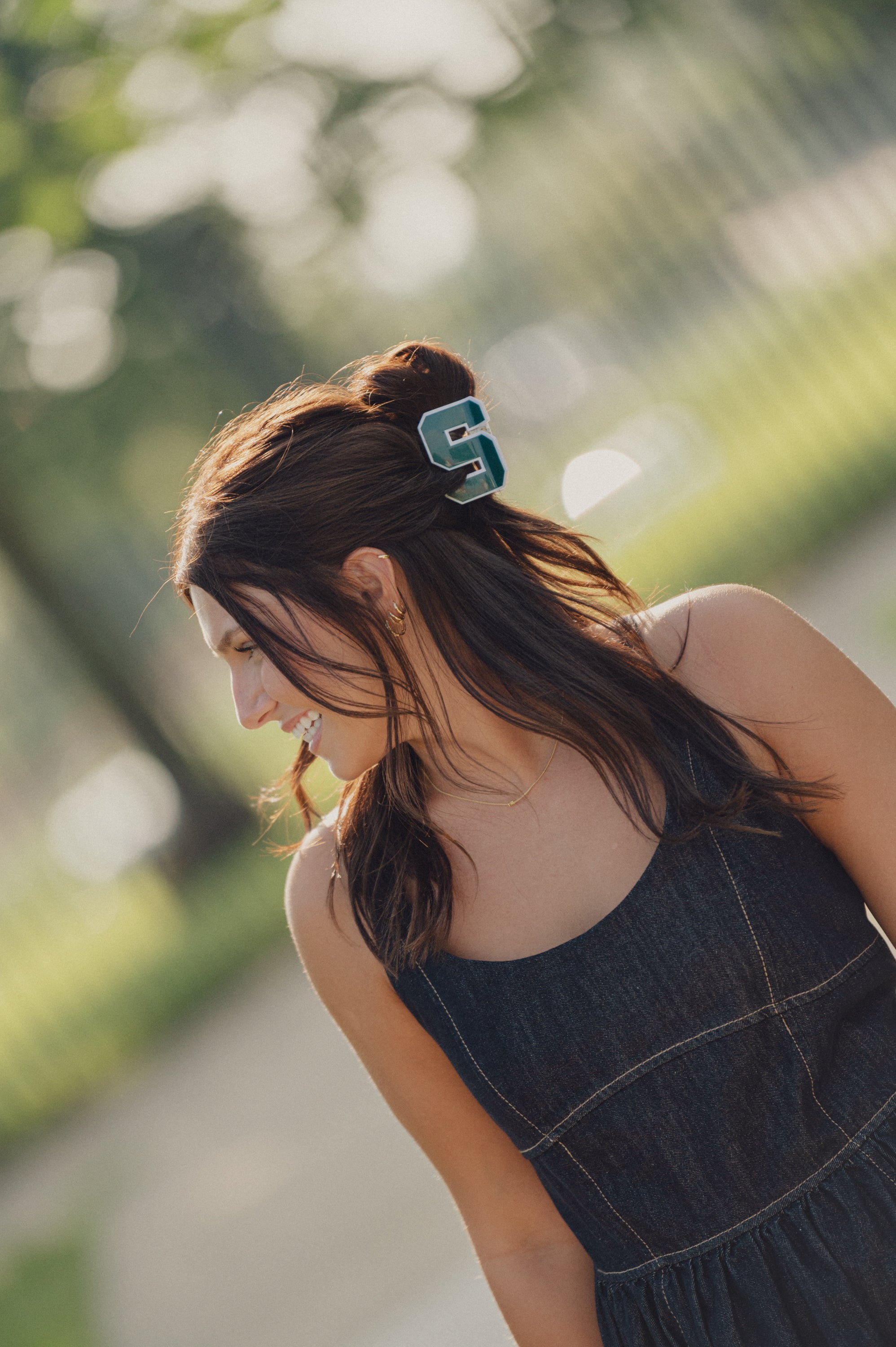 Woman with a Spartan block S green hair clip.