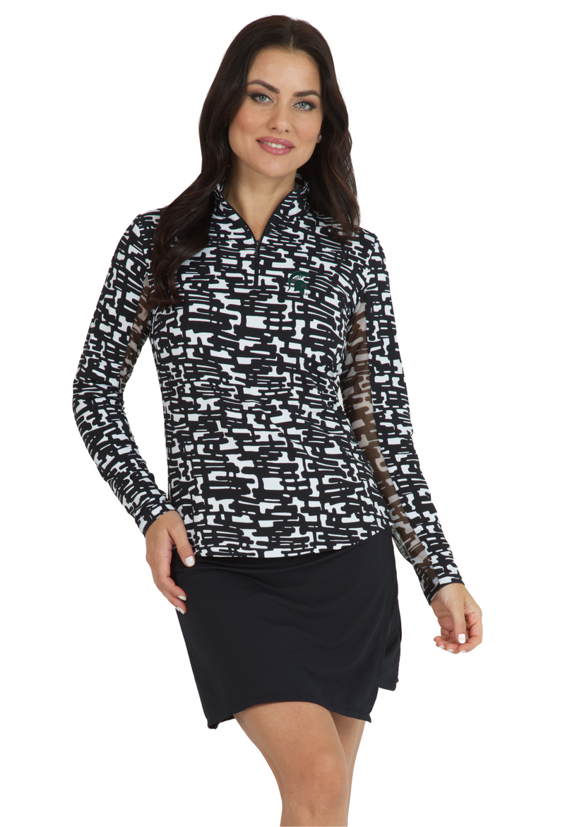 A woman wearing a black and white long sleeve quarter-zip athletic top with a geometric pattern.